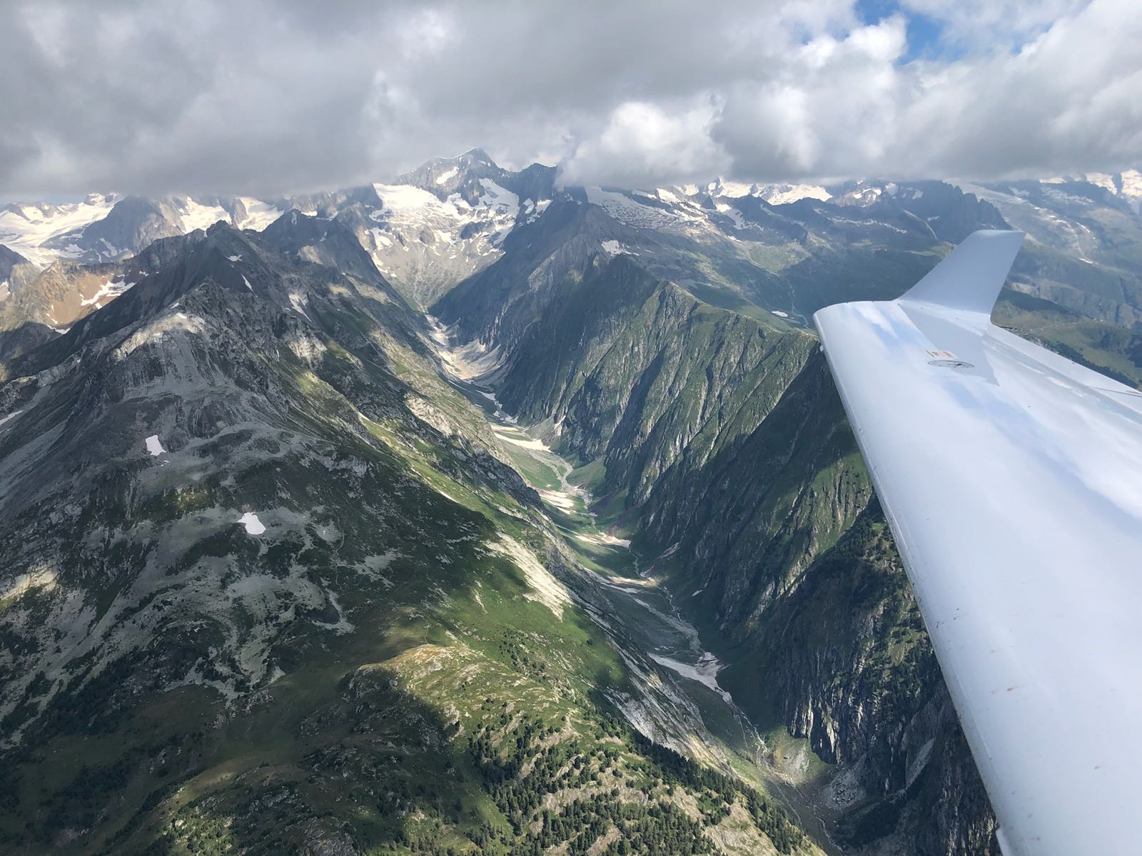 View over an alpine glacial valley from the DA40 NG